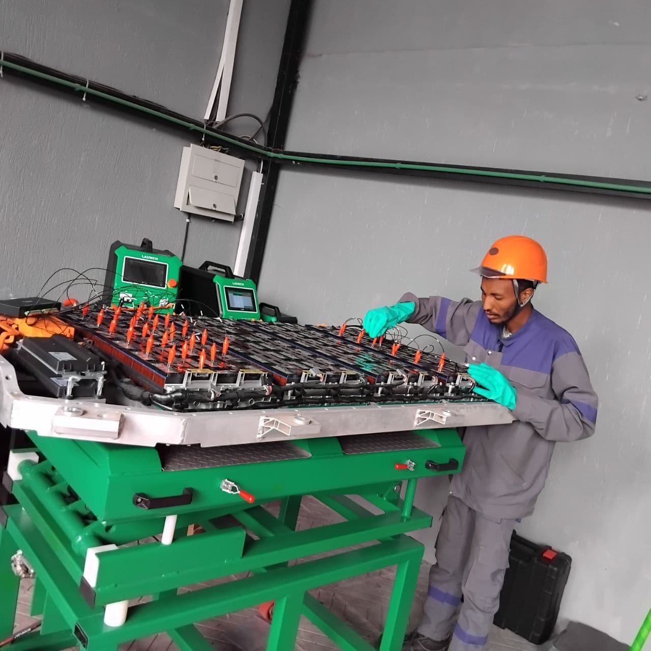 A FairFix technician working on an EV battery pack